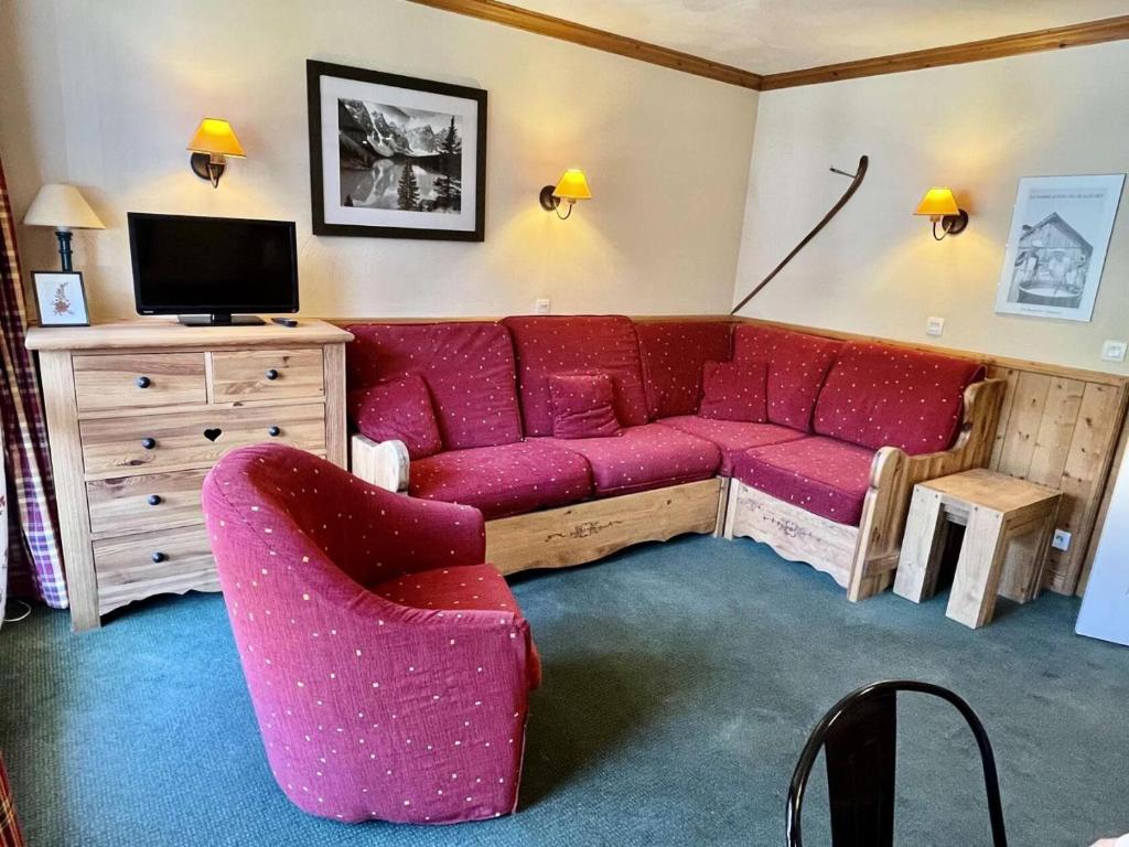 un salon avec un canapé rouge et une télévision dans l'établissement Résidence Valeriane - La Valériane 212 - Joli 3 pièces, vue magnifique sur les montagnes MAE-5194, à Valmorel