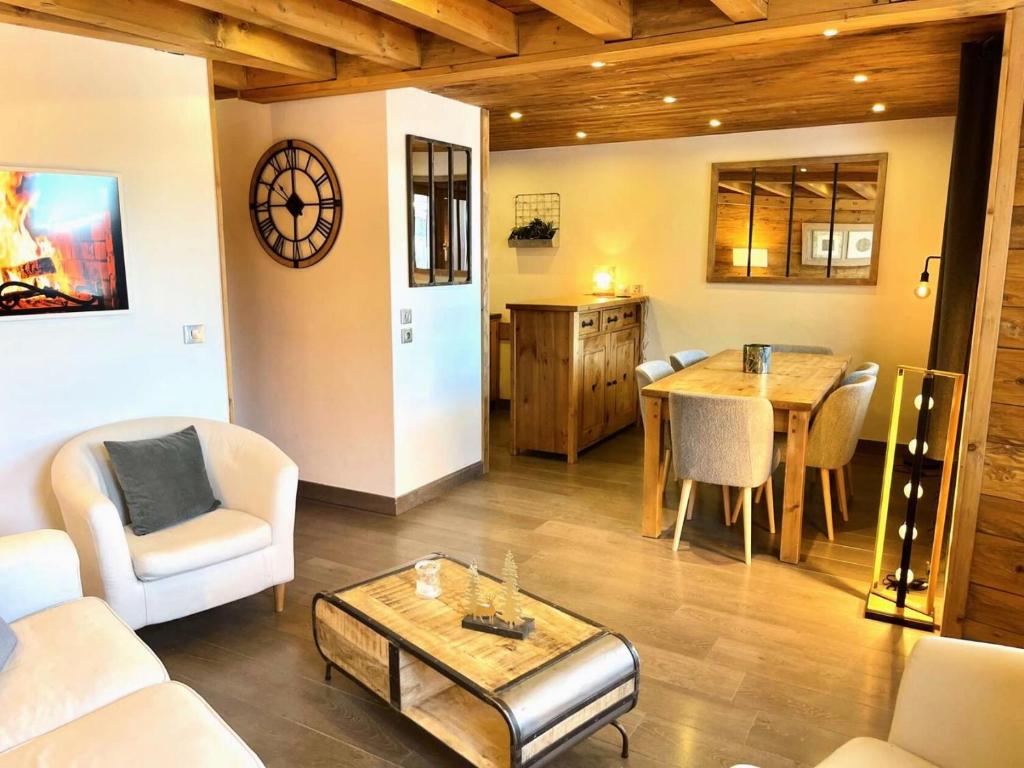 a living room with a table and a dining room at Résidence Terrasse - La Terrasse 36 - Magnifique appartement cocooning, vue splendide MAE-4914 in Valmorel