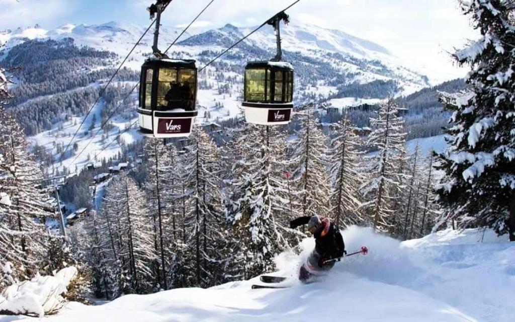 a man riding a ski lift in the snow at Résidence Canteneige - 2 Pièces pour 7 Personnes 514 in Vars