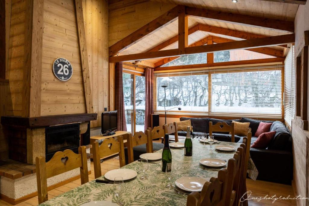 a dining room with a table and a fireplace at Résidence -les Deux Alpes - Chalets 844 in Vénosc