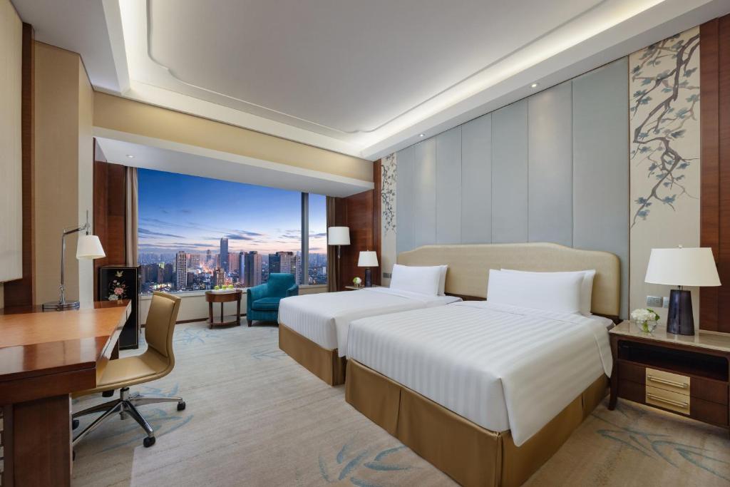 Postel nebo postele na pokoji v ubytování Shangri-La Hefei