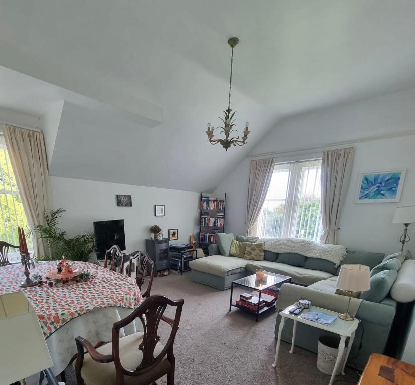 a living room with a couch and a table at Scotts Lodge Newcastle County Down in Newcastle