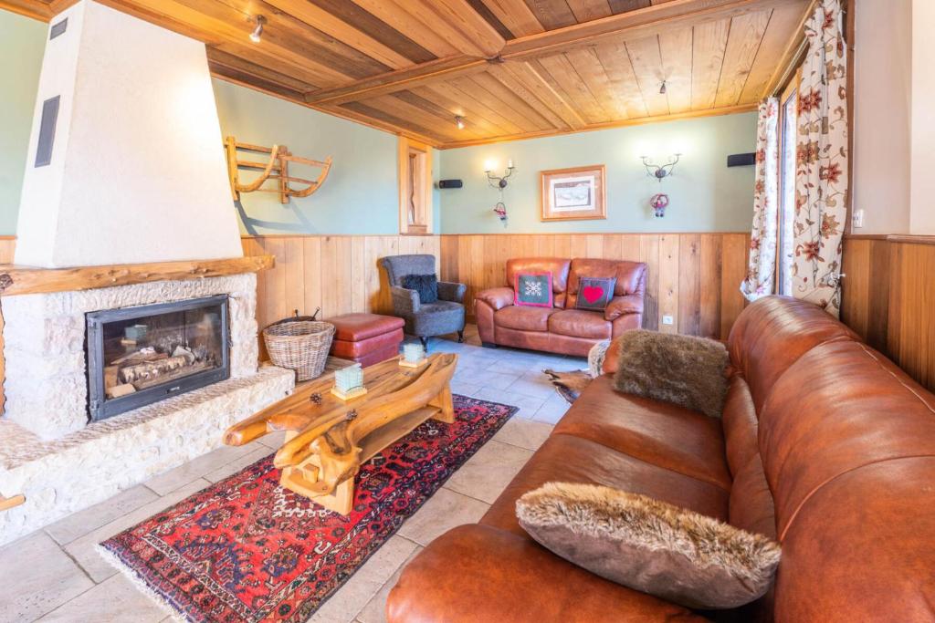 a living room with a couch and a fireplace at Chalet Dauphin - Chalets pour 15 Personnes 264 in LʼHuez