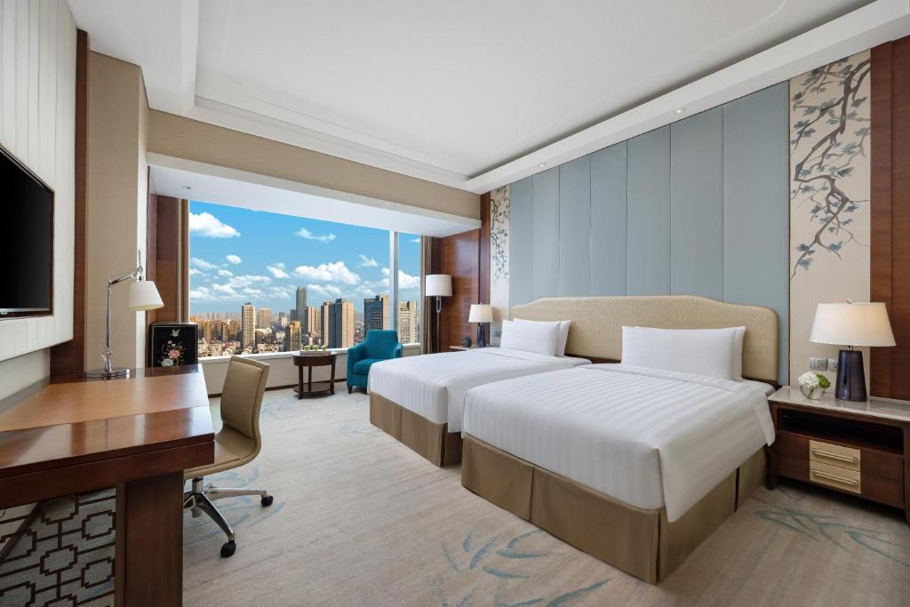 Postel nebo postele na pokoji v ubytování Shangri-La Hefei