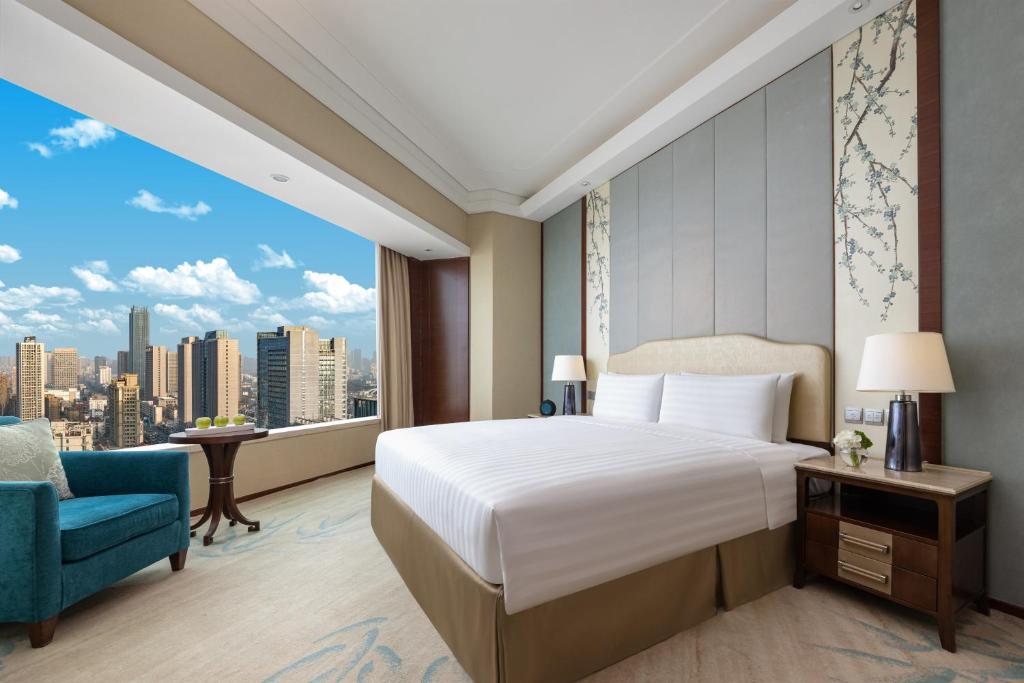 Postel nebo postele na pokoji v ubytování Shangri-La Hefei