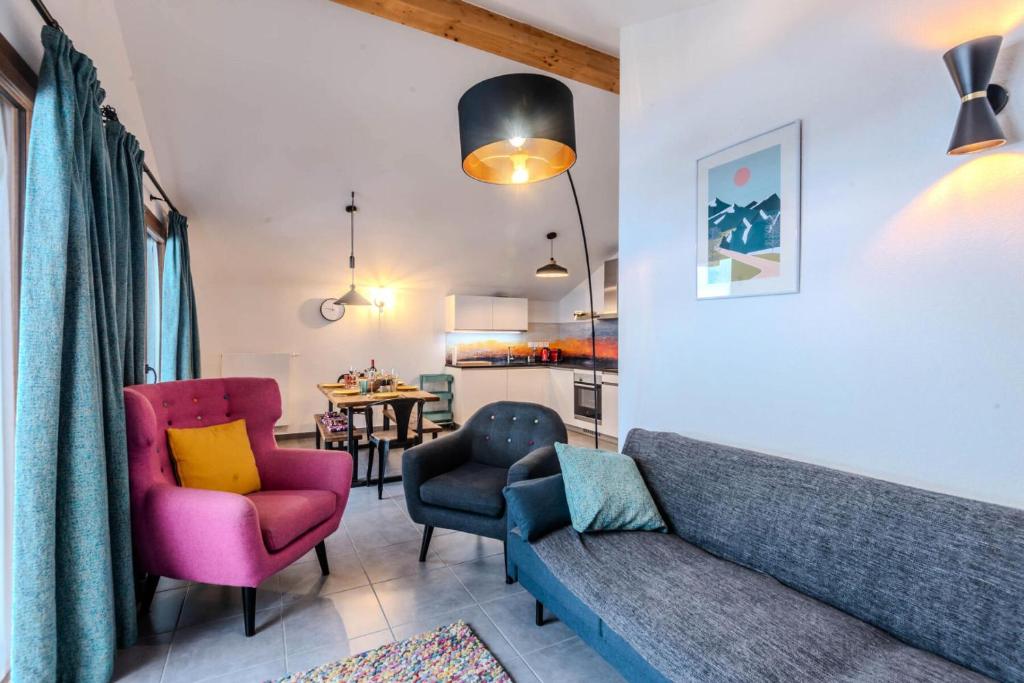 a living room with a couch and two chairs and a table at Chalets Brunes - 3 Pièces pour 6 Personnes 544 in Morzine