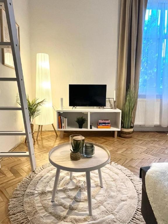 a living room with a tv and a table at Apartment Cecil - Old Town in Bratislava