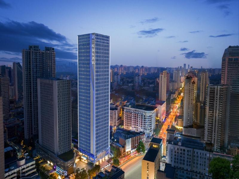 a city skyline with a tall skyscraper at LanOu Hotel Changsha Wuyi Square in Changsha