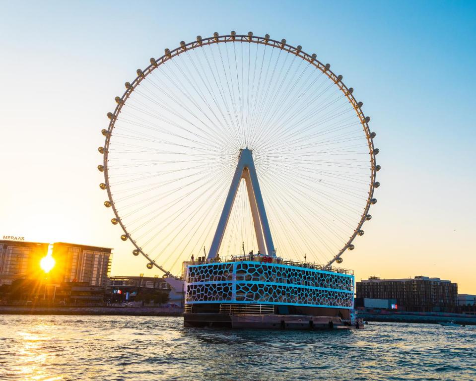 a large ferris wheel sitting in the water at Overnight Super Yacht - Orchid in Dubai