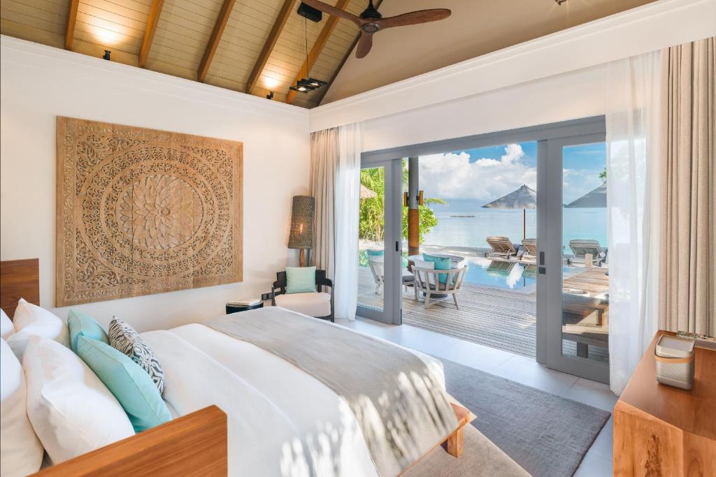 a bedroom with a bed and a view of the ocean at Vakkaru Maldives in Baa Atoll