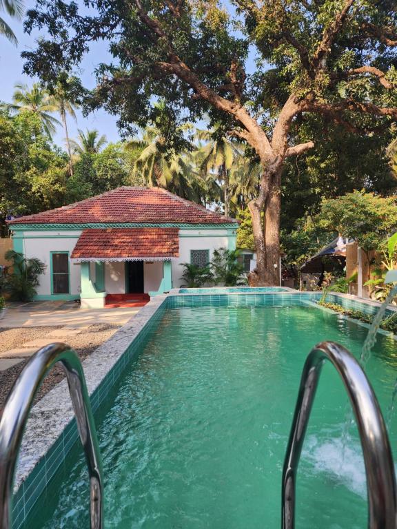 a swimming pool in front of a house at Casa Happy Dervish, 2mins away from the beach in Anjuna