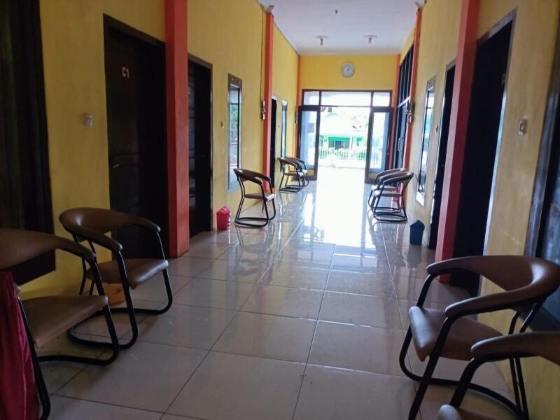 an empty hallway with chairs in a building at OYO 91232 Hotel Garuda in Sumenep