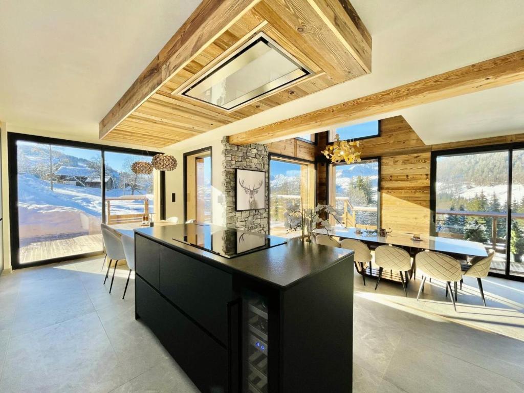 a kitchen and dining room with a table and chairs at Chalet - Chalets 101 in Notre-Dame-de-Bellecombe