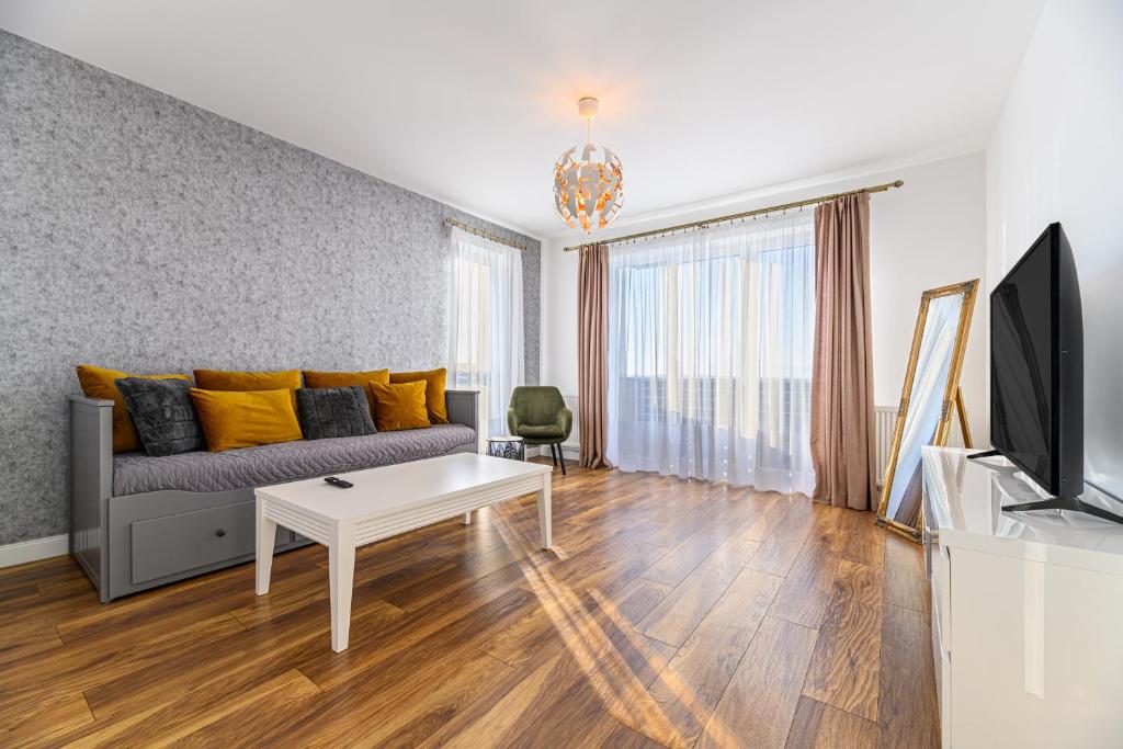 a living room with a couch and a table at KOA - Sunlight Apartment in Braşov