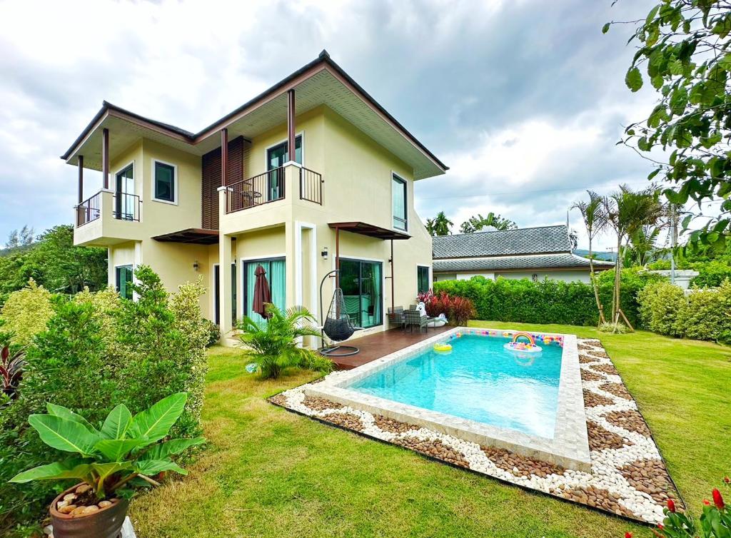 a house with a swimming pool in the yard at Krabi Aonang & Alpha villa in Ao Nam Mao