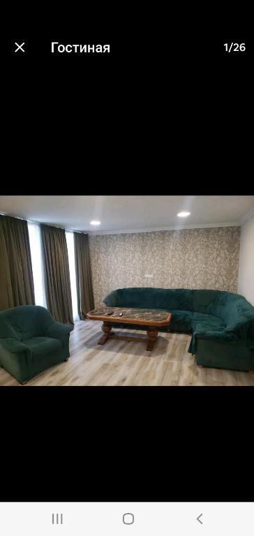 a living room with a couch and a table at My home 1 in Kiketʼi