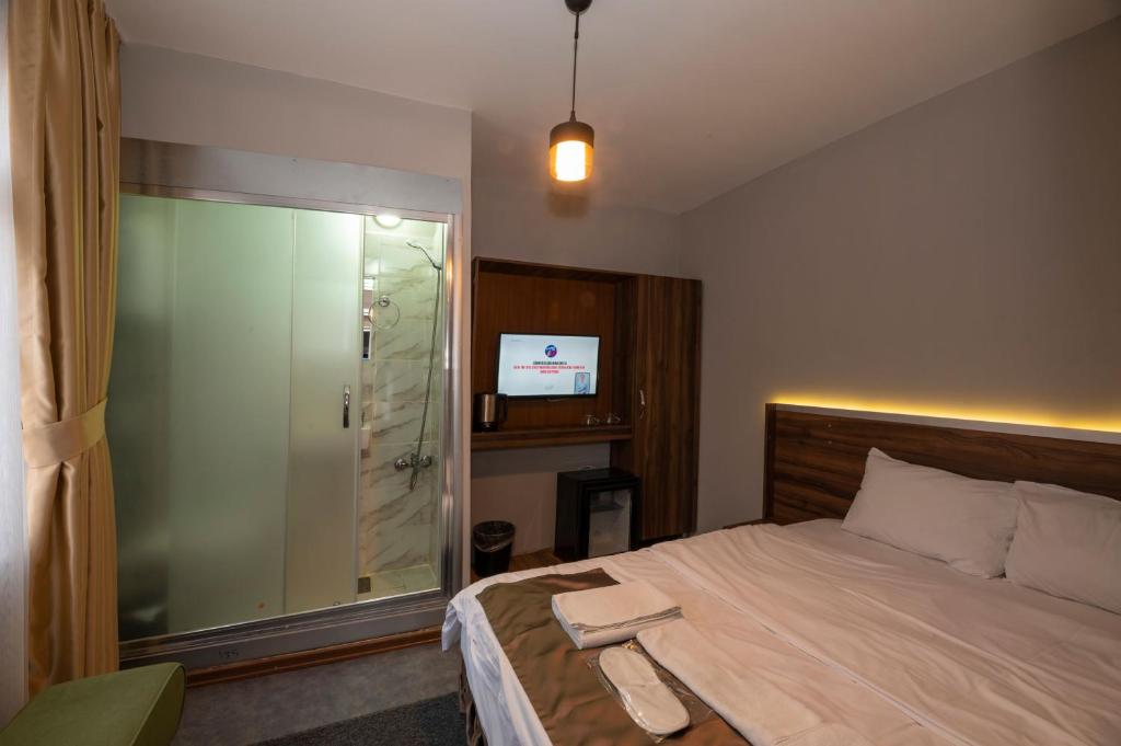A bed or beds in a room at Boutique Central Taksim