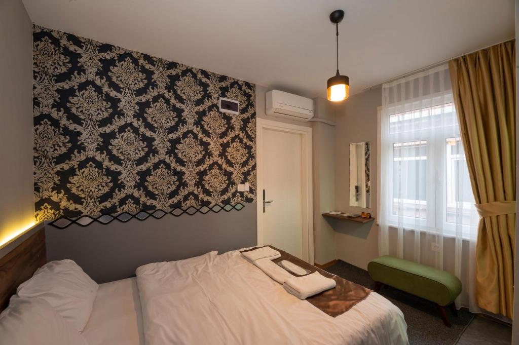 A bed or beds in a room at Boutique Central Taksim