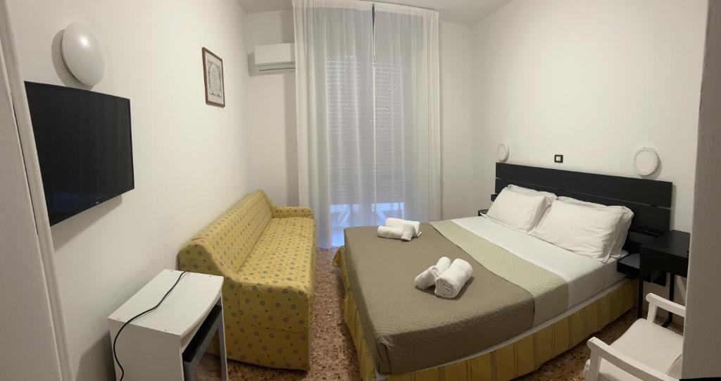 Postel nebo postele na pokoji v ubytování Hotel Perla