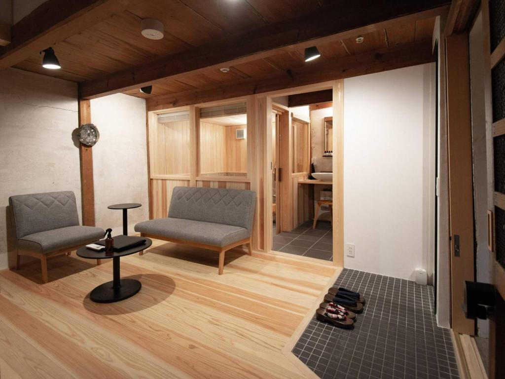 a living room with two chairs and a table at NIPPONIA HOTEL 伊賀上野 城下町 in Iga