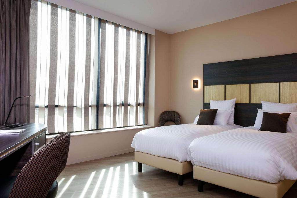 Postel nebo postele na pokoji v ubytování Best Western Plus Hôtel Escapade Senlis