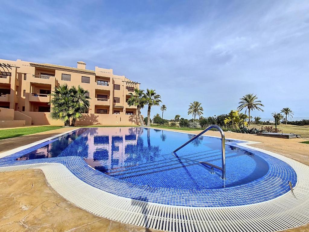 a large swimming pool in front of a building at La Serena Apartment - 3410 in Los Alcázares