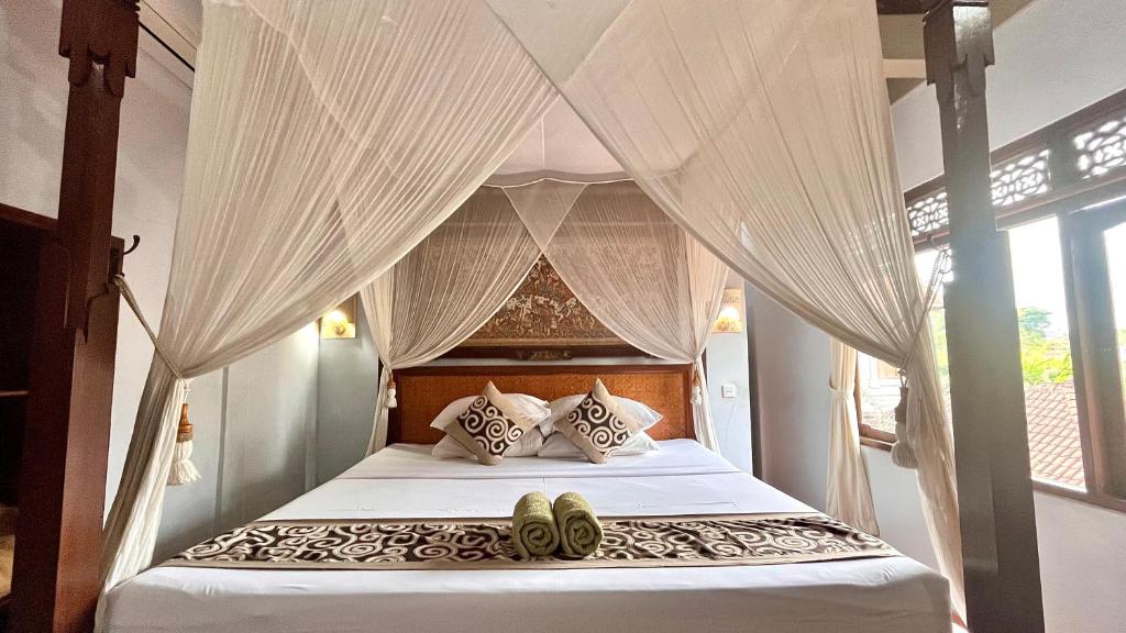 Postel nebo postele na pokoji v ubytování Bali Moon Guest House
