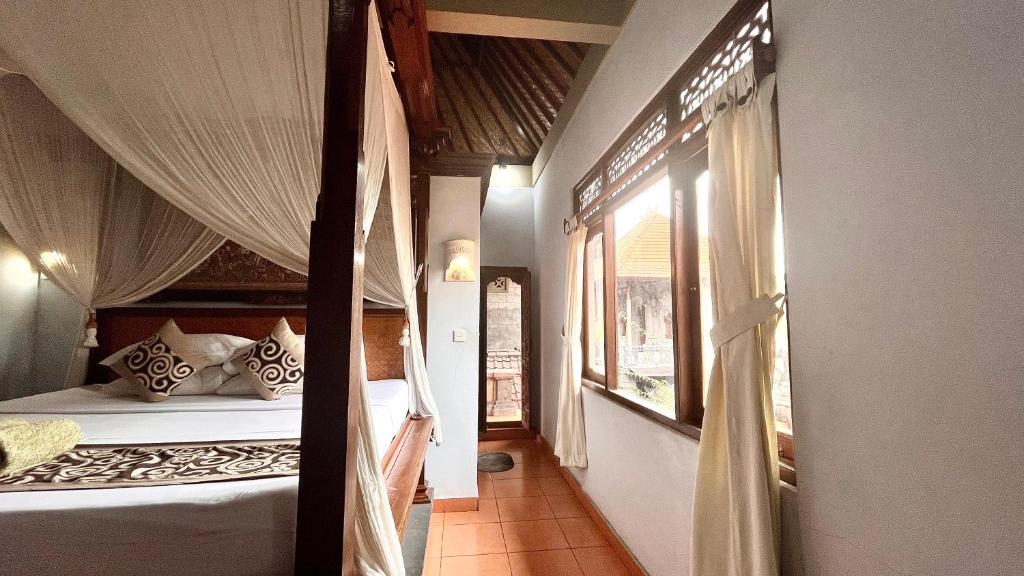 Postel nebo postele na pokoji v ubytování Bali Moon Guest House
