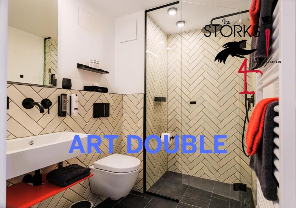 an art bathroom with a toilet and a shower at Hotel Bad Hofgastein - The STORKS - Adults Only in Bad Hofgastein
