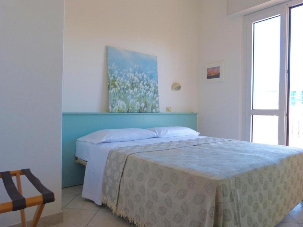 Postel nebo postele na pokoji v ubytování HOTEL D'ANNUNZIO