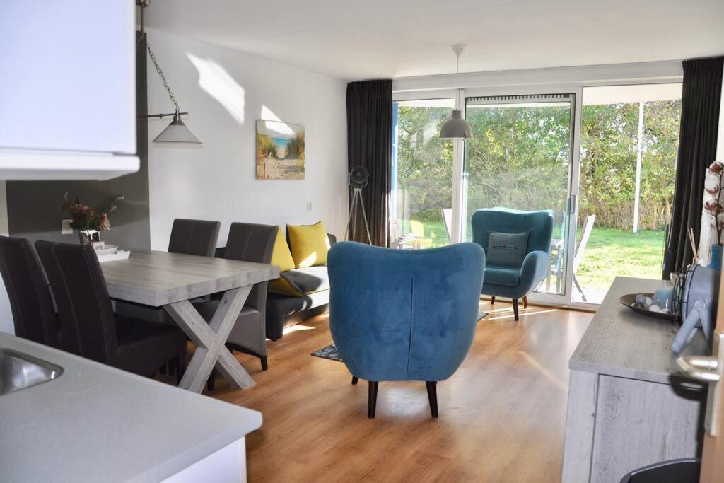a kitchen and living room with a table and chairs at Appartement Badhotel 301 in Callantsoog