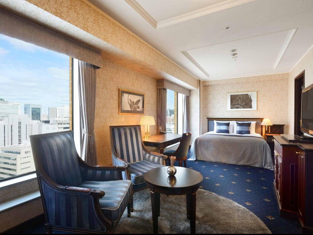 Postel nebo postele na pokoji v ubytování Nagoya Kanko Hotel