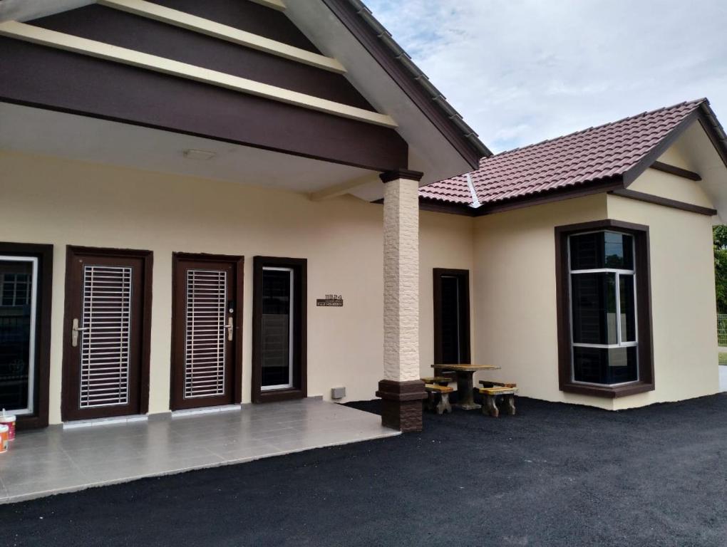a home with a patio and a house at Tulz Homestay @ Melaka in Malacca