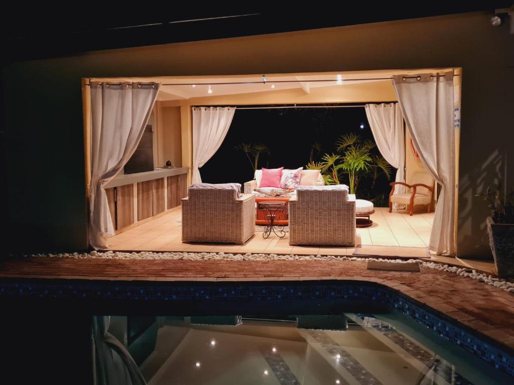 a view of a living room from a swimming pool at Be My Guest in Upington