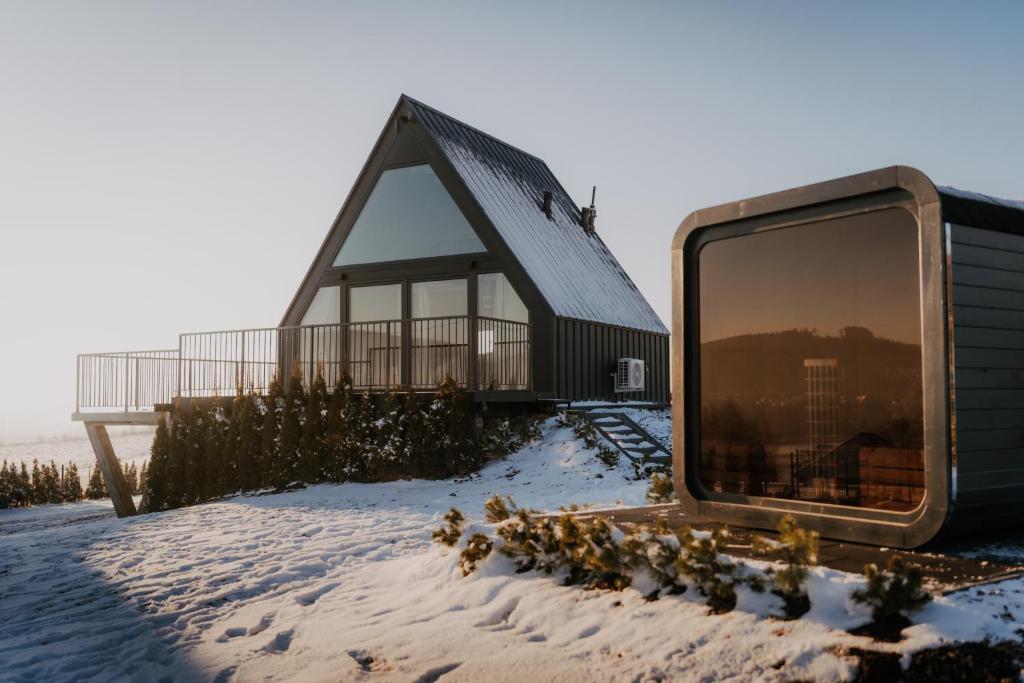 a large tv sitting in the snow in front of a building at SkyGlamp in Ustroń