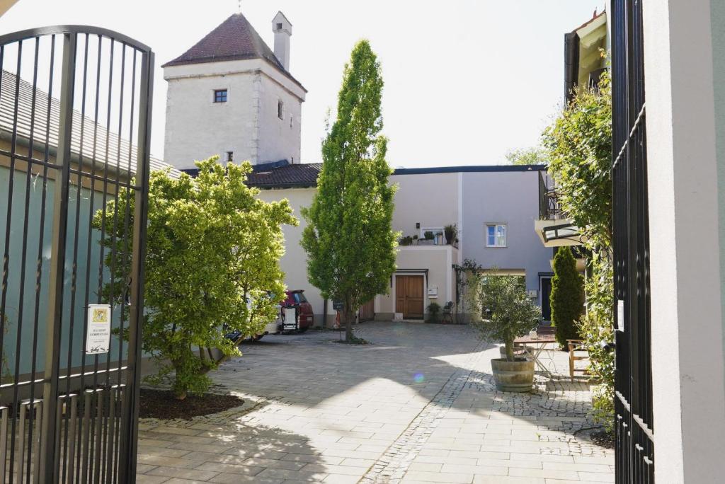 a view from a gate of a building with a church at Boutique-Hotel am Ledererturm in Kelheim