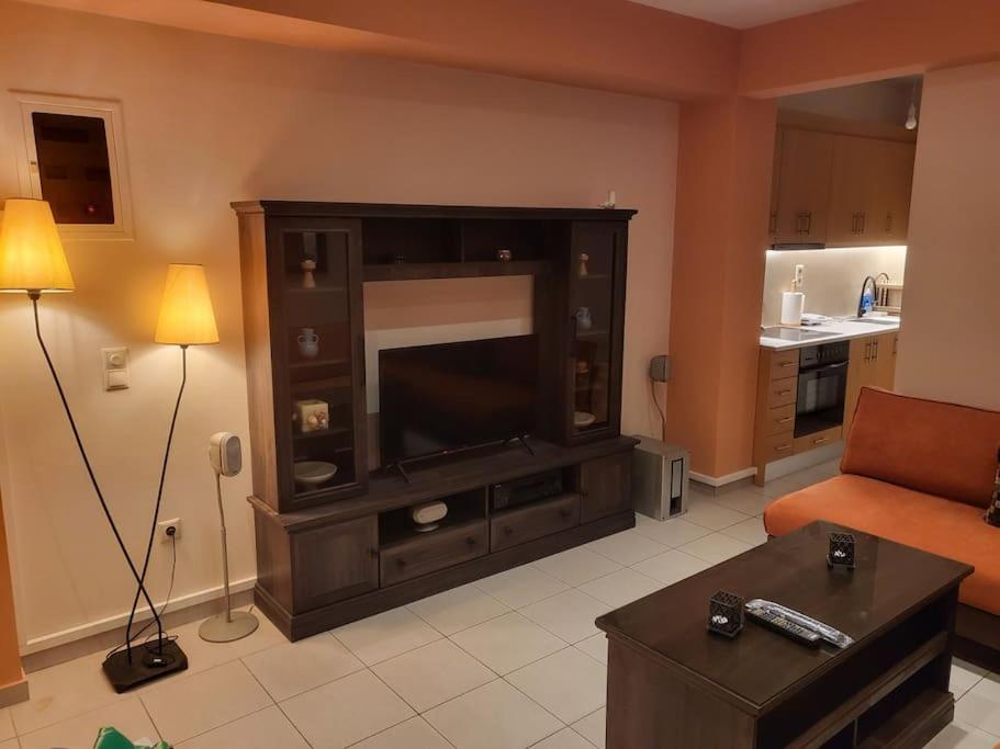 a living room with a large entertainment center with a television at Independent and newly built apartment in Kallithea, next to Tavros train station, in a nice neighborhood in Athens