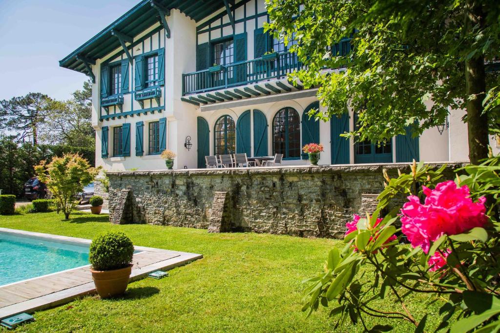 una casa con piscina junto a un patio en Maison Cuevas, en Biarritz