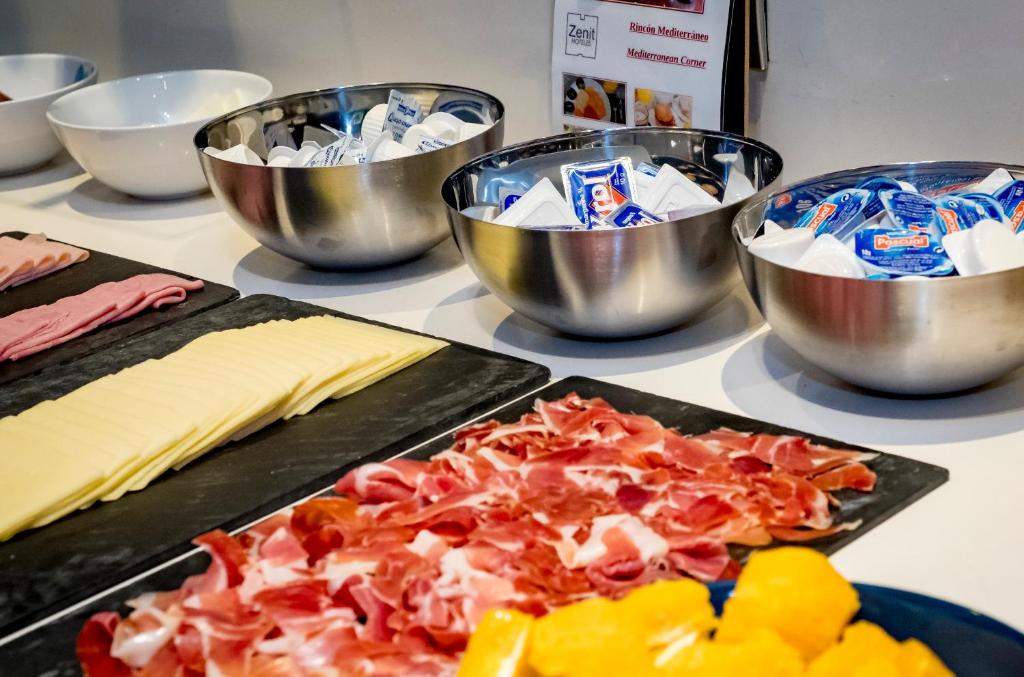 a group of bowls and plates of food on a counter at Zenit Valencia in Valencia