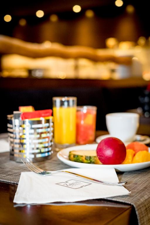 a table with a plate of food and fruit on it at Zenit Valencia in Valencia