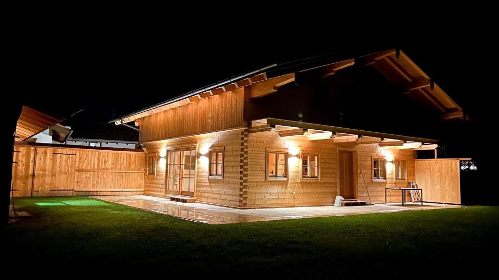 uma casa iluminada à noite com luzes em Ferienhaus Seerose em Übersee