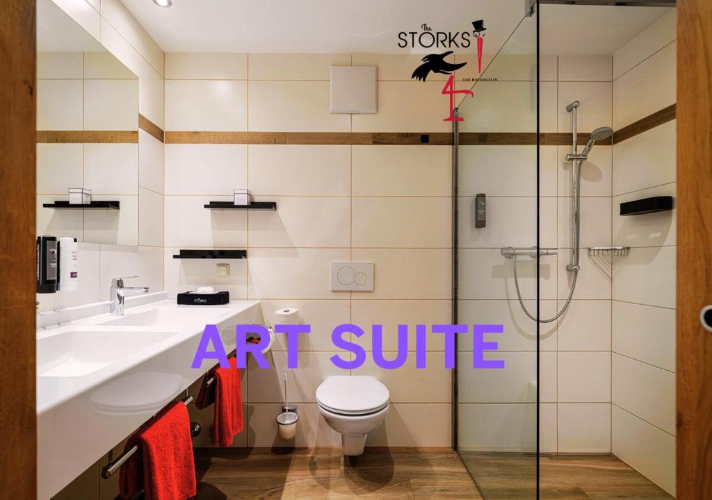 an art suite bathroom with a toilet and a shower at Hotel Bad Hofgastein - The STORKS - Adults Only in Bad Hofgastein