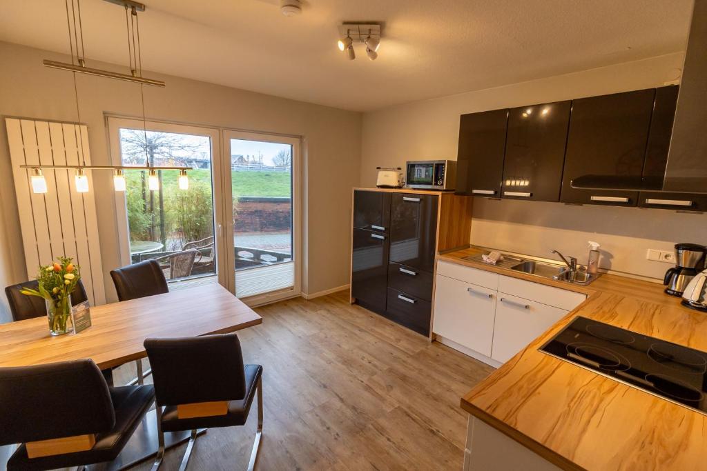 a kitchen with a table and a dining room at Dieknüst in Greetsiel