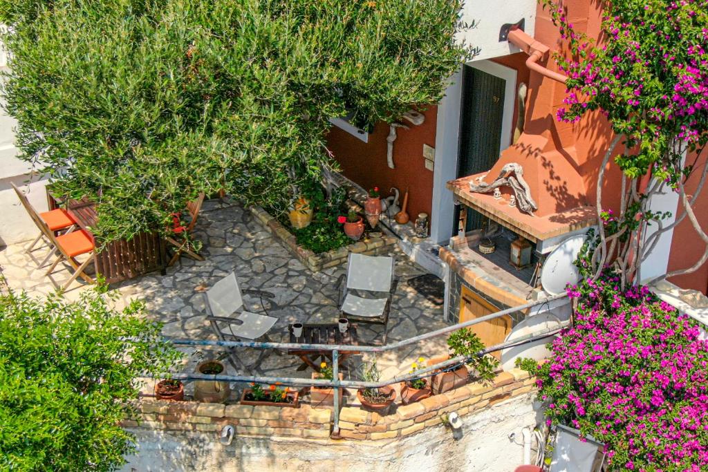 an aerial view of a patio with chairs and flowers at Athena's Veranda magestic views in Glyfada beach of Corfu by New Era in Glyfada