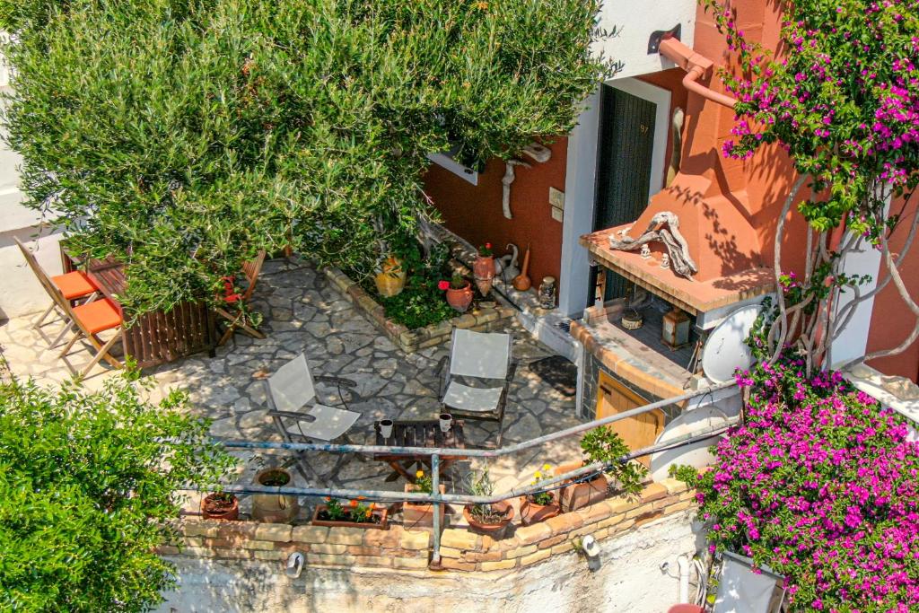 an aerial view of a patio with chairs and flowers at Athena's Veranda magestic views Home 97 in Glyfada of Corfu by New Era in Glyfada