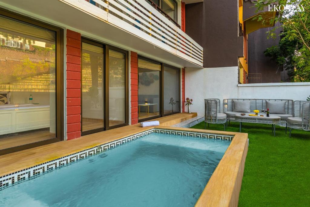 a swimming pool in the backyard of a house at EKOSTAY Luxe - Casa Marina in Candolim