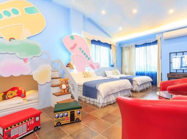 a childrens bedroom with two beds and a toy train at Elegance House in Wujie