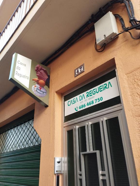 a sign for a restaurant on the side of a building at CASA DA REGUEIRA in Redondela