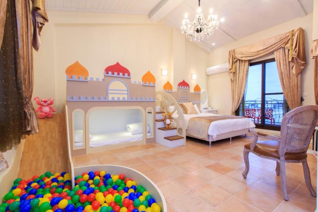 a castle themed bedroom with a bed and a pile of balls at Elegance House in Wujie