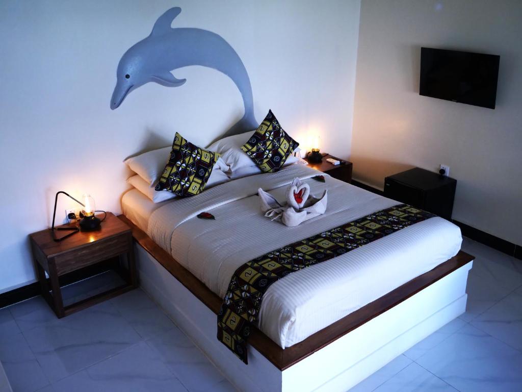 Postel nebo postele na pokoji v ubytování Double A Nungwi Beach Hotel